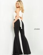 Model in Jovani M02807 showing back view and tied detail of jumpsuit.