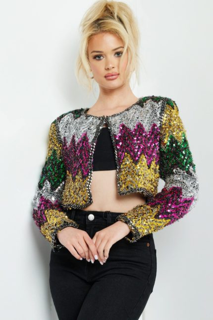 Model wearing Jovani M05037 multi-color sequin jacket with black top and pants.