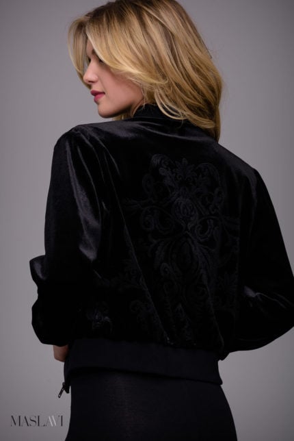 Model wearing M51285 black velvet jacket with floral embroidery from the back.