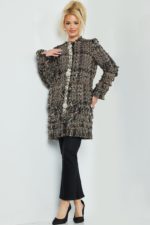 Model wearing Jovani M54805 tweed coat in multi-color with focus on texture and embellished accents.