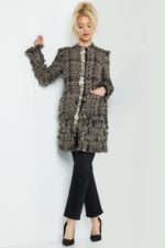 Model wearing Jovani M54805 knee-length tweed coat with embellished buttons and long sleeves in multi-color.