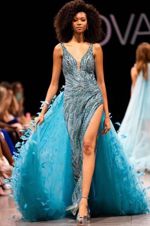 Model wearing Jovani S23074 Teal Embellished V Neckline Couture Dress