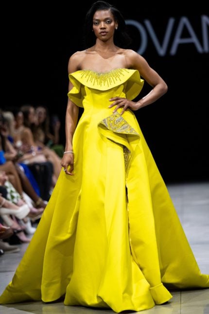 Model wearing Jovani S36369 yellow gown with off-the-shoulder neckline and beaded detail