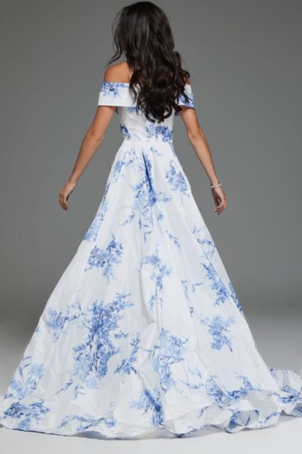 Model wearing Jovani S38939 front view of white and blue off-the-shoulder dress with floral patterns.