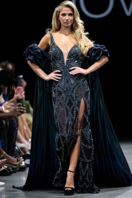 Model wearing Jovani S39121 black gown with a plunging neckline and high slit