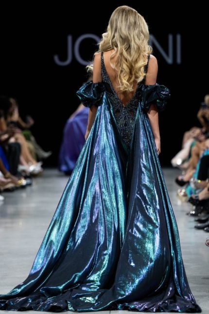 Back view of model wearing Jovani S39121 showcasing cape and beadwork