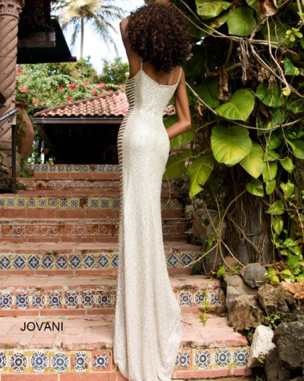 Model wearing Jovani S4261 silver gown with square neckline and side cut-outs, back view