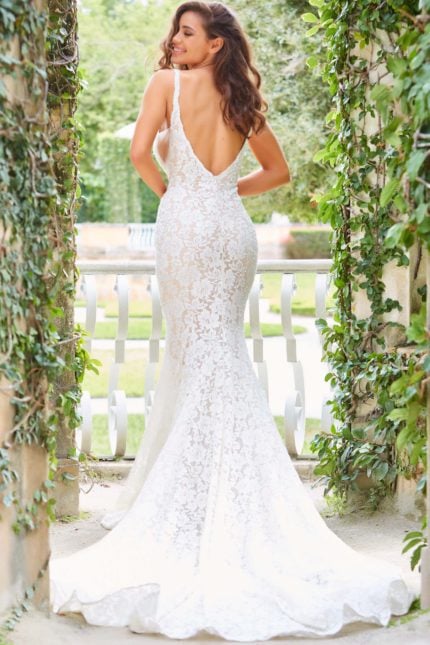 Model wearing Jovani JB03864 ivory dress, showcasing the low-cut back design.