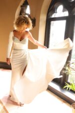 Model showcasing Jovani 24262 white gown with sweetheart neckline.