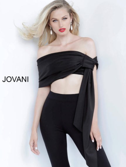 Model wearing Jovani 68693 black off-the-shoulder top with elegant draping.